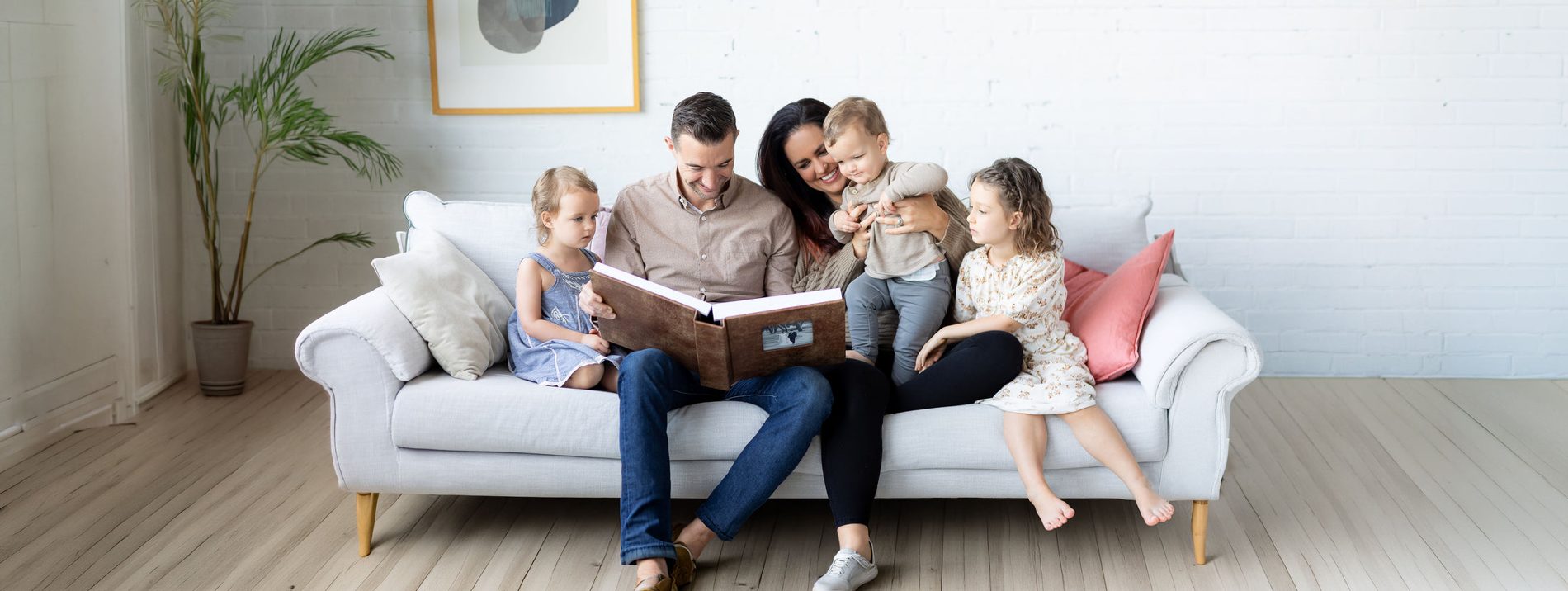 Sample client photograph — a family on a sofa — shown inside the cameo window