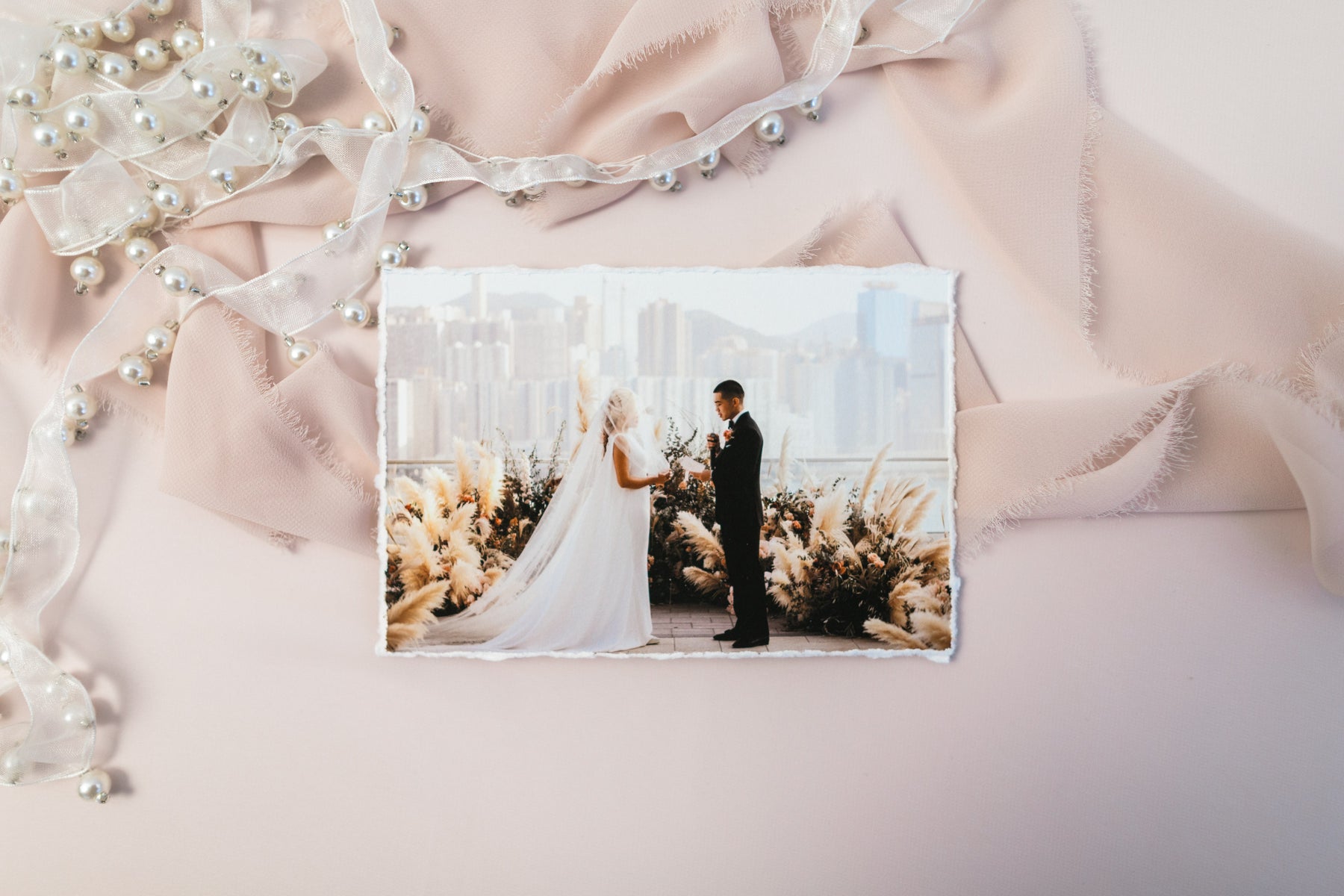 A linen presentation box standing open with a print resting beside it