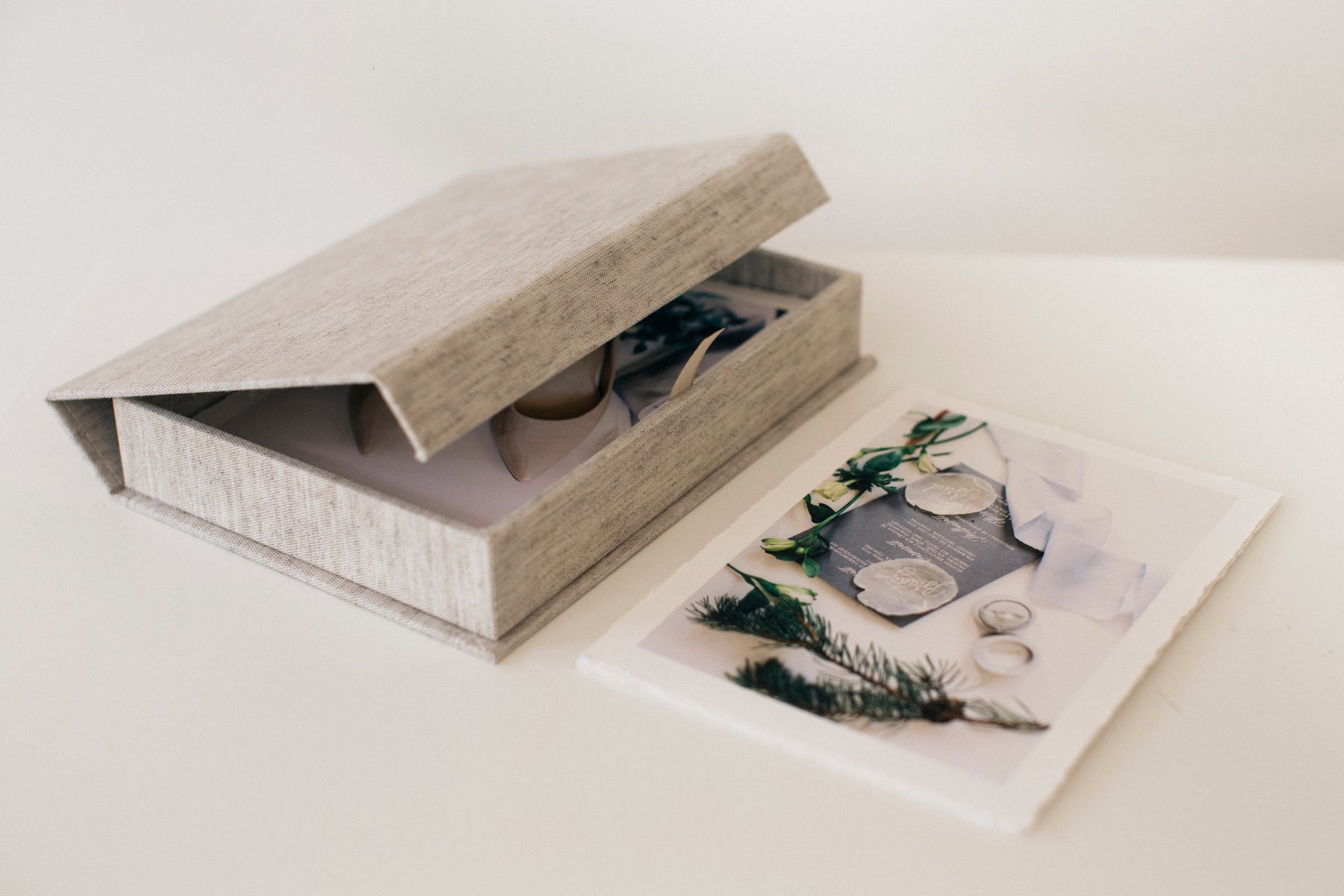 A large photographic print of a wedding couple, lying on soft white fabric